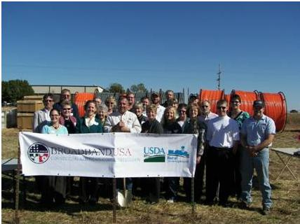 The CEO and employees of the Madison Telephone, LLC, the engineering firm and construction firm representatives, local, county and state elected officials break ground on a broadband project that will bring jobs and opportunity to part of rural Kansas. 