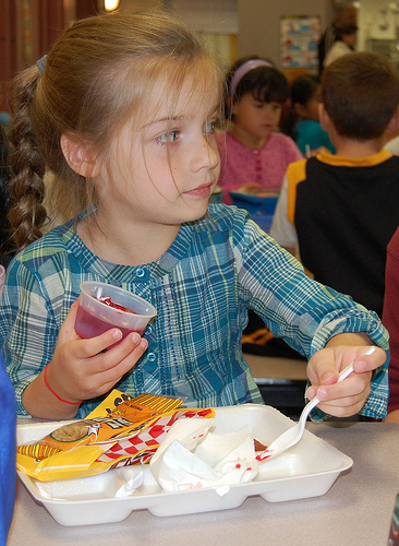 First-grader Cassidy Stone clears her tray of soy nuts, whole wheat pizza stick, broccoli and jello, saying “the food tastes good.”