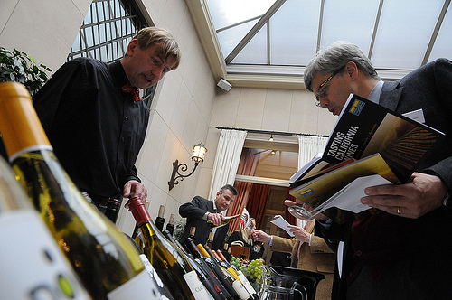 Brothers Geert (left) and Jan Desmet (center), owners of Vinam, a California wine specialist company in Belgium, offer samples to guests at the March 7 wine tasting organized by the Foreign Agricultural Service (FAS) in cooperation with the Wine Institute.  (Photo Courtesy of the U.S. Embassy in Belgium)Brothers Geert (left) and Jan Desmet (center), owners of Vinam, a California wine specialist company in Belgium, offer samples to guests at the March 7 wine tasting organized by the Foreign Agricultural Service (FAS) in cooperation with the Wine Institute.  (Photo Courtesy of the U.S. Embassy in Belgium)