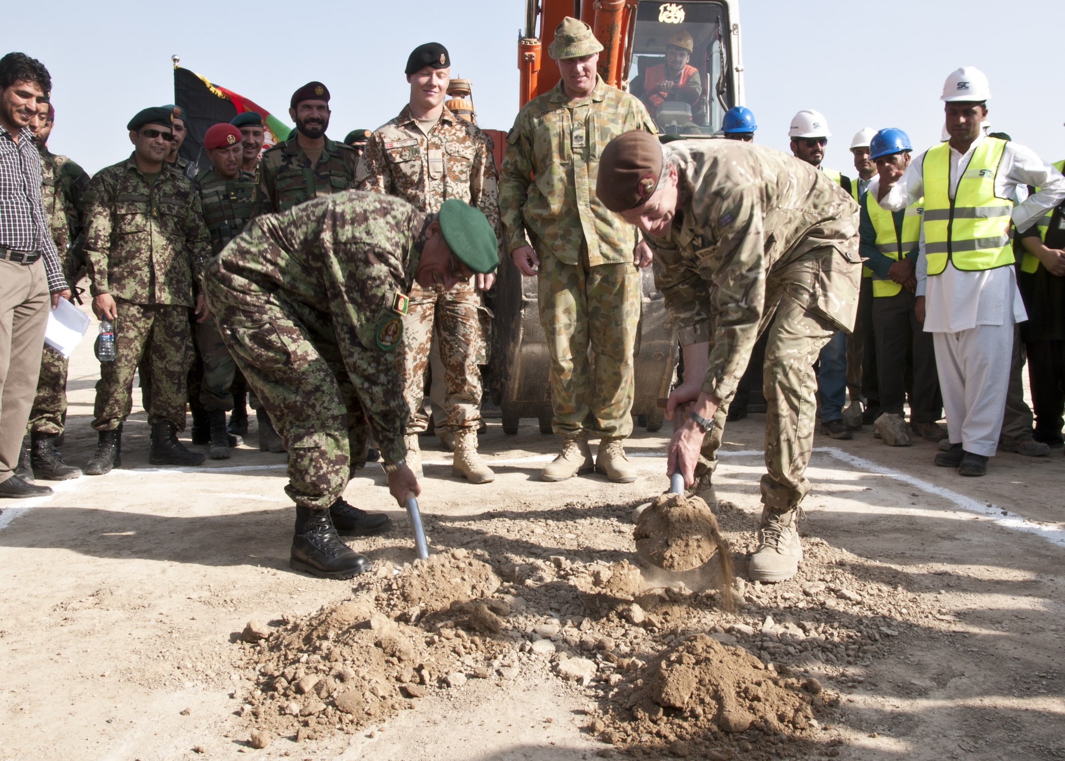 Gen. Sher Mohammad Karimi, Chief of General Staff for the ANA, and Lt. Gen. Adrian J. Bradshaw, Deputy Commander ISAF, dig the first holes ground breaking ceremony for the Afghanistan National Army Officers Academy, 11 Oct. Photo by MC3 (SW) Sean Weir, NTM-A Public Affairs.