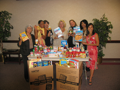 Lupe Gomez, Coordinator and WIC staff show their contributions to the food drive.