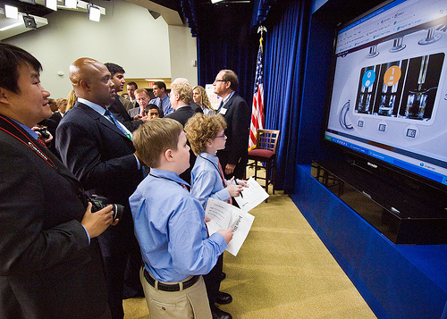 From left: Peter Rhee, United States Department of Agriculture, Office of Communications grabs a few photographs for the USDA Blog as former Washington Redskins Running Back Brian Mitchell competes against brothers Frederick, Antonio and Joseph Blackwell (not shown) in the the computer game, “Smash Your Food.” “Smash Your Food” is the Third Place winning app in the The Apps for Healthy Kids games competition. Frederick won the game and a signed replica Pro Bowl helmet from Mitchell. The Apps for Healthy Kids competition is part of First Lady Michelle Obama’s Let’s Move campaign to end childhood obesity within a generation. The competition challenges software developers, game designers, students and other innovators to develop fun and engaging software tools and games to urge children, especially “tweens” (children ages 9-12) – directly or through their parents – to eat better and be more physically active. The applications are software tools or games for the web, personal computer, mobile handheld device, console or any software platform available to the public. The winners were honored at the White House, Wednesday, September 29. USDA Photo 10di15067-24 by Bob Nichols.