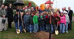 Students, School, and USDA officials plant a tree in Utah. 