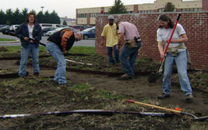 NRCS employees dig out paths and install borders and landscape fabric. 