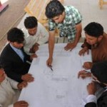 Engineer Omid (standing) explains the design features of a project on Camp Zafar to the new class of Afghan engineer quality assurance representatives.