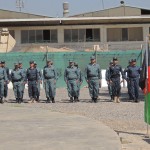 Afghan National Police graduates standing in formation waiting to receive their certificates, Sept. 20 at Camp Nathan Smith, Kandahar Province, Afghanistan. The officers just graduated the first fully Afghan run police officer course at this particular training center. (US Navy photo by Petty Officer 2nd Class Ronald Pitts, RSC-S/NTM-A PAO)