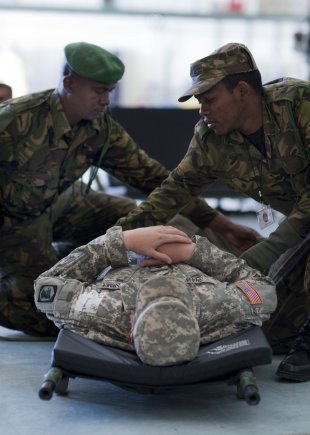 Spc. Benjamin Shaw, a combat engineer with the 404th Maneuver Enhancement Brigade, Illinois Army National Guard out of Chicago, receives medical treatment from the Botswana Defence Force during a mass casualty training exercise at Southern Accord 2012, located at Thebephatshwa Air Base in Botswana, Aug. 14, 2012. SA12 is a combined, joint exercise, which brings together the Botswana Defence Force with U.S. Forces to strengthen their partnership through humanitarian assistance, peacekeeping operations and aeromedical evacuation.