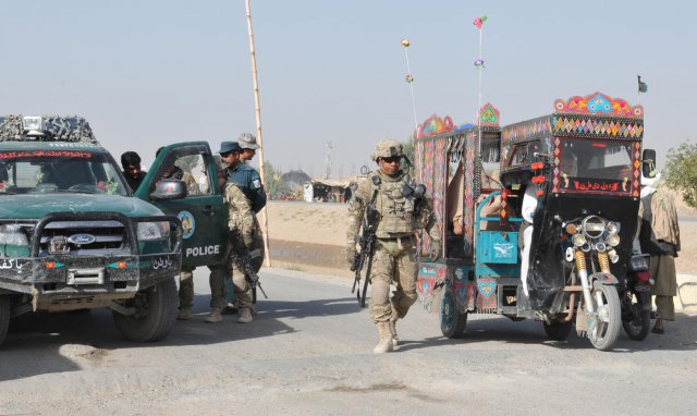 Soldiers of 563rd Military Police Company, currently deployed to southern Afghanistan as part of Combined Task Force Lancer, 2nd Stryker Brigade Combat Team, prepare to mount up with their Afghan Uniform Police partners for Operation Clean Sweep conducted in districts throughout Kandahar City, Oct. 3, 2012. The 563rd Soldiers reunited with their AUP partners for the first time in weeks after the threat of insider attacks was minimized.