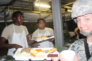 Pfc. Tyrone Price and Sgt. Derrick Powe, food service specialists with the 144th Transportation Company, serve dinner to Soldiers during the Department of the Army-level Philip A. Connelly Award Field Kitchen category competition Nov. 19, 2011, at Camp Blanding Joint Training Center. (U.S. Army photo by Capt. Daisy Bueno, 50th Regional Support Group)