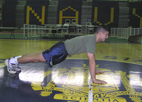 Young man in pushup starting position