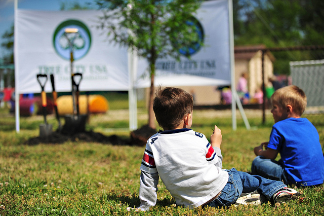 Gabriel Antor, left, and Nickolas Seeger, right, sit and wait for a tree to be planted at the Langley Air Force Base, Va., child development center, April 25, 2012. The tree, which could live hundreds of years if properly cared for, was planted in honor of National Arbor Day. U.S. Air Force photo by Senior Airman Jarad A. Denton/Released. 