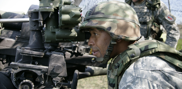 U.S. Army Field Artillery Sergeant Sibert verifying adjustments