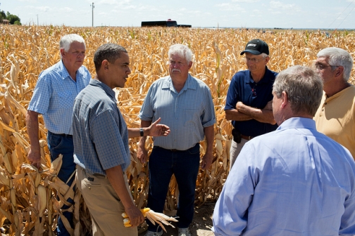 President Barack Obama talks with farmers during a tour of the McIntosh family farm