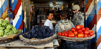 SSG Paul Campbell and his interpreter speak with an Iraqi shop owner