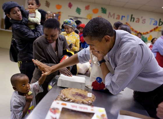 President Barack Obama gets a high five at Martha’s Table