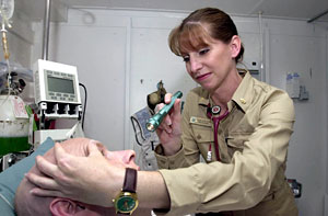 Military physician examing a patient