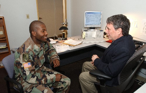 Photo of service member and VA employee