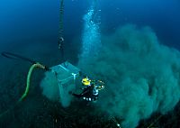 Chief Navy Diver Eric Eberle, assigned to Mobile Diving and Salvage Unit (MDSU) 2, Company 4, inspects the operation of a suction dredge system during an underwater recovery operation in search of an missing service member.