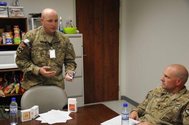 A 10th Sustainment Brigade soldier listens on as Staff Sgt. Rouven Sefcik,
a noncommissioned officer in charge of combat stress with the 455th Expeditionary Medical Operation Squadron explains the function of the playaway listening device, Aug. 7, 2012, at Bagram Airfield, Afghanistan.