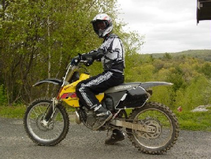 A young man on his dirtbike get ready to ride the trail at Thomaston Dam, Thomaston, Conn. Trail bike riding is a popular activity at the project, and the trail area on the west side of the reservoir was formally designated in 1975. (U.S. Army Corps of Engineers photo)