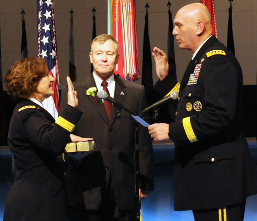 Lt. Gen. Patricia D. Horoho is sworn in as 43rd Army surgeon general by Army Chief of Staff Gen. Raymond T. Odierno, while her husband retired Col. Ray Horoho looks on.
