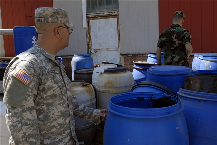 Maj. Jose Velazquez, Ponce, Puerto Rico, the chief engineer for Multinational Battle Group East, inspects barrels full of hazardous waste during an inspection of a battery factory in Gjilan/Gnjilane, Kosovo. Velazquez was at the factory assisting members of the Kosovo Security Force for the inspection. Velazquez, a member of the Puerto Rico National Guard, is deployed as part of the NATO peacekeeping mission in Kosovo. (U.S. Army photo by Jerry Boffen, 130th Public Affairs Detachment)