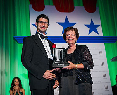 Jacob Taylor receiving the service to America Medal from Acting Commerce Secretary Rebecca Blank