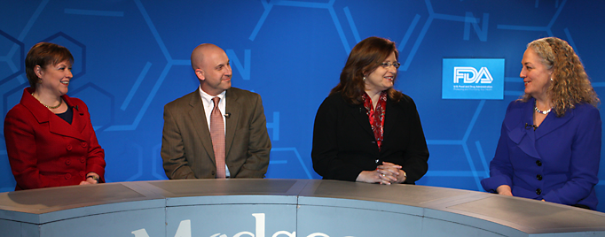 Panel of Individuals Sitting Around Table