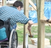 Volunteer who uses a wheelchair working on Honolulu ABILITY House