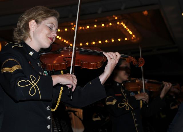 HONOLULU, Hawaii-Soldiers of the The U.S. Army Band Strolling Strings musical ensemble, from Washington D.C., entertain the audience at the 235th Army Birthday Commemoration, at the Hilton Hawaiian Village, here, June 12.