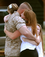 Returning Solider Hugging Family