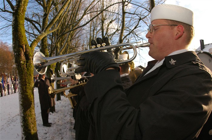 HAMM, Belgium &mdash; Navy Petty Officer 2nd Class Franklin Raasch, a bugler for the Sixth Fleet Ceremonial Band, plays &#34;Taps&#34; as U.S. military and foreign service representatives lay several wreathes at the General George S. Patton memorial park in Bastogne, Belgium. Dec. 18, 2004. The ceremony was one of many U.S. European Command members are participating in to remember the 60th anniversary of the end of World War II.  
(DoD Photo by Petty Officer 1st Class Ted Banks)