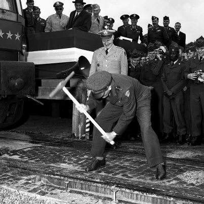 Photo: Archive Photo of the Day: Gen. Hoge's ceremonial swing at Kaiserslautern, 1954.
 
It was halfway around the world from Promontory Summit, Utah, and the last spike wasn't golden, but the soldiers from the 432nd Engineer Construction Battalion watching Gen. William M. Hoge, USAREUR commander-in-chief, take a ceremonial swing could relate to the workers on the transcontinental railroad in 1869. The event at Kaiserslautern, Germany, in September, 1954 marked the completion of a three-mile rail spur built by the 432nd from Kaiserslautern's main station to Panzer Casern. Hoge was something of a World War II engineering Zelig, being deeply involved in such endeavors as the construction of the Alaska Highway, the D-Day landing at Omaha Beach, and the capture of the famed bridge at Remagen and the crossing of the Rhine that followed.
(Neil Doherty/Stars and Stripes)
 
More about the Kaiserslautern spike ceremony: http://1.usa.gov/RkY5m7
