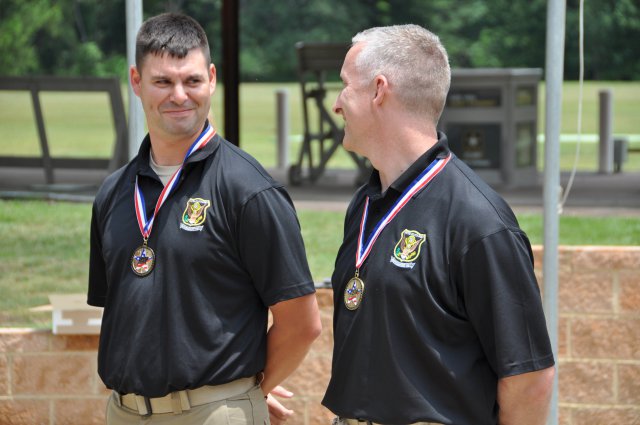 Staff Sgt. Michael McPhail (left) and Sgt. 1st Class Eric Uptagrafft, U.S. Army Marksmanship Unit, share a laugh during the awards ceremony June 5, 2012, at Hook Range on Fort Benning, Ga. McPhail won the U.S. Olympic Team Trials Rifle Prone match, earning his first berth to the Olympics. He will join Uptagrafft, who had qualified for the same event last year. McPhail and Uptagrafft will shot Aug. 3, 2012, for a gold medal.