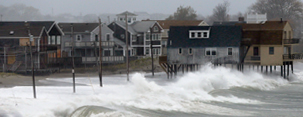 Image: Ocean waves kick up near homes along Peggoty Beach in Scituate, Mass. Monday, Oct. 29, 2012 (© Elise Amendola/AP)