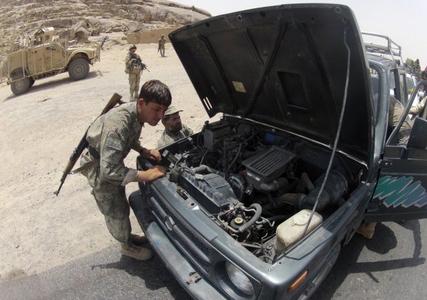 Afghan Border Police members search a truck at Checkpoint 9 along Highway 4 in the district of Spin Boldak, Afghanistan, July 5, 2012. This Afghan Border Police checkpoint is one of the few that operates 24/7.