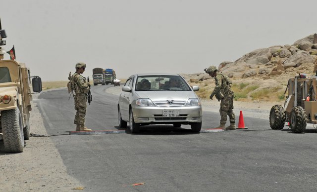 Sgt. Joseph Barrow and Spc. Anthony Saenz, members of Alpha Company, 1st Battalion, 17th Infantry Regiment, 2nd Infantry Division, conduct traffic control operations at Checkpoint 9 along Highway 4 in the district of Spin Boldak, Afghanistan, July 5, 2012. This Afghan Border Police checkpoint is one of the few that operates 24/7.