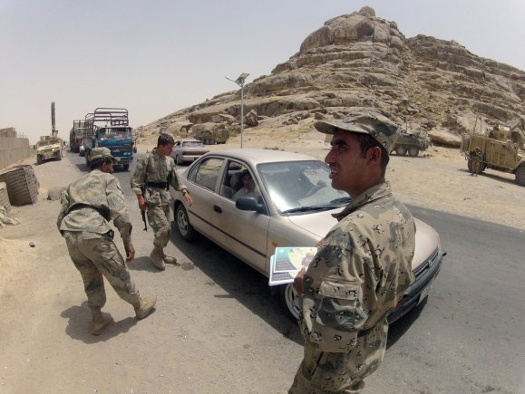 Members of the Afghan Border Police conduct an inspection of a vehicle at Checkpoint 9 along Highway 4 in the district of Spin Boldak, Afghanistan, July 5, 2012. This Afghan Border Police checkpoint is one of the few that operates 24/7.