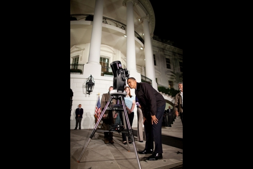 President Barack Obama looks through a telescope 