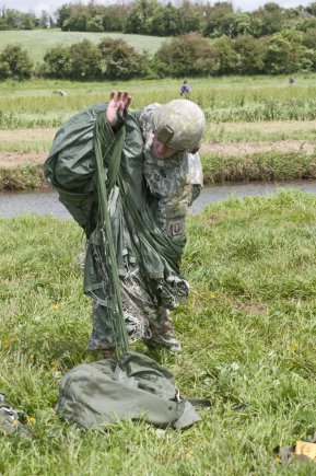 Sgt. 1st Class Kyle Sessoms, 82nd Airborne Division, packs up his parachute after completing a jump onto La Fiere, France, June 3.
Sessoms is part of the Task Force 68, which is made up of paratroopers from U.S., Germany, France, Holland, and United Kingdom, re-enacted the D-Day airborne operation on the La Fiere fields near Ste. Mere Eglise, France, to commemorate the heroic acts of the World War II paratroopers who made the jump 68 years ago. After the jump, the task force marched into the town of Ste. Mere Eglise to the sounds of cheers from the locals. Task Force 68 is in Normandy, France, to commemorate the 68th anniversary of D-Day.