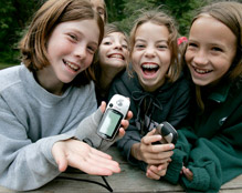 kids smiling and holding gps units