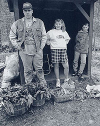 Ray Dickens, Jr. Kimberly Dickens, and Jeffrey Honaker at their roadside stand 