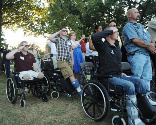 Wounded Warriors from Walter Reed National Medical Center, Md., salute during the national anthem at the Twilight Tattoo performed on Whipple field at Joint Base Myer-Henderson Hall, Va., Aug. 29, 2012.