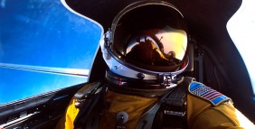 A U-2 pilot looks outside while flying the aircraft.
