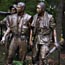 Soldiers looking at Vietnam Wall Memorial