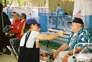 Interviewing a man with a hat with a flag