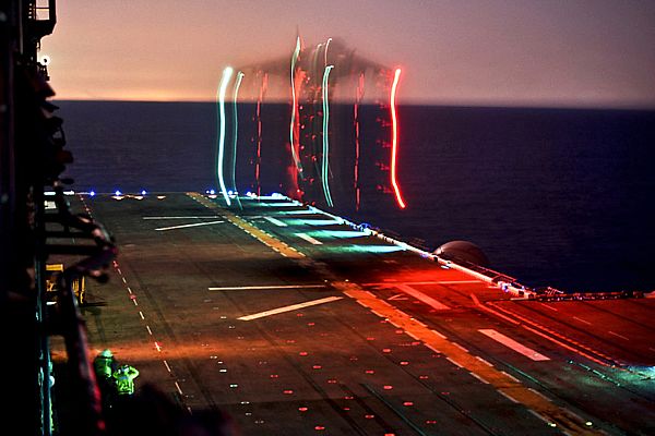 A Marine Corps Harrier AV-8B II conducts nighttime launch and recovery operations.