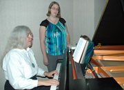a veteran with music therapist playing piano