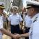 Commander, Carrier Strike Group 2 greets a Coast Guard officer aboard Barque Eagle