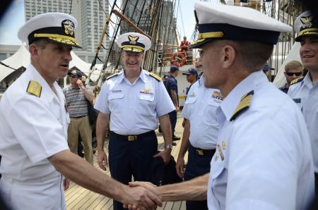 Commander, Carrier Strike Group 2 greets a Coast Guard officer aboard Barque Eagle